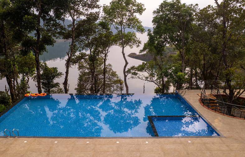 Swimming pool overlooking lush Wayanad greenery