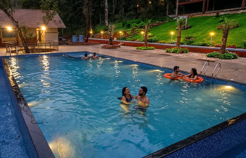 Resort pool with Banasura hills in the background